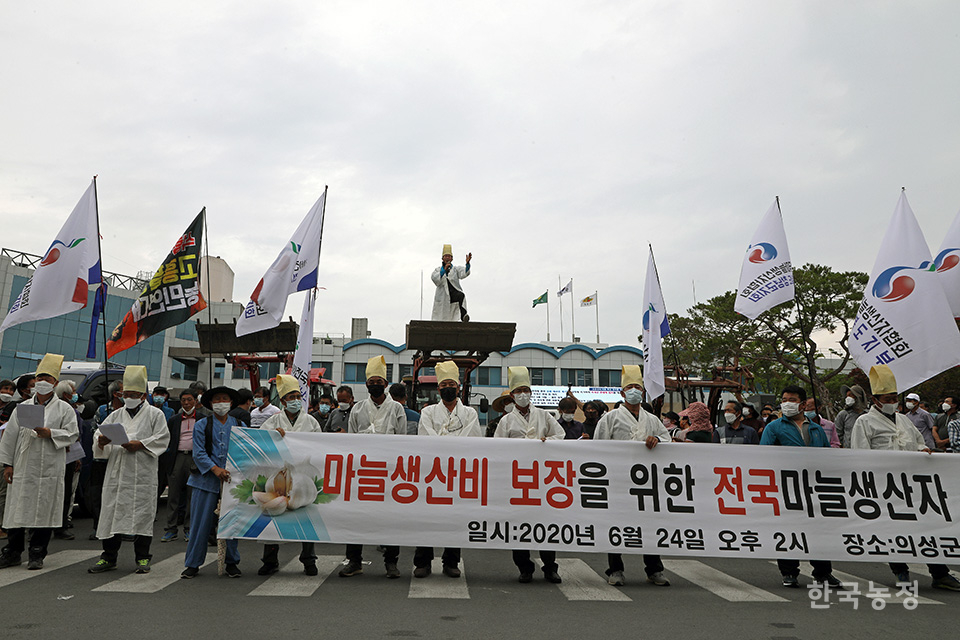 지난해 6월 24일 경북 의성군청 앞에서 열린 ‘마늘생산비 보장을 위한 전국마늘생산자 기자회견’에서 전남 해남에서 온 한 농민이 트랙터에 올라 마늘생산비 보장을 위한 대책 마련을 정부에 촉구하고 있다. 한승호 기자
