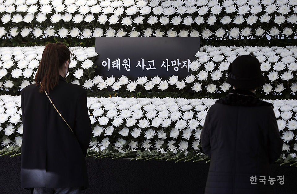 이태원 압사 참사 희생자를 기리는 시민들의 발걸음이 이어지는 가운데 2일 오전 서울 용산구 이태원역 1번 출구에 마련된 추모 공간을 찾은 한 시민이 희생자의 명복을 빌며 촛불을 켜고 있다. 한승호 기자