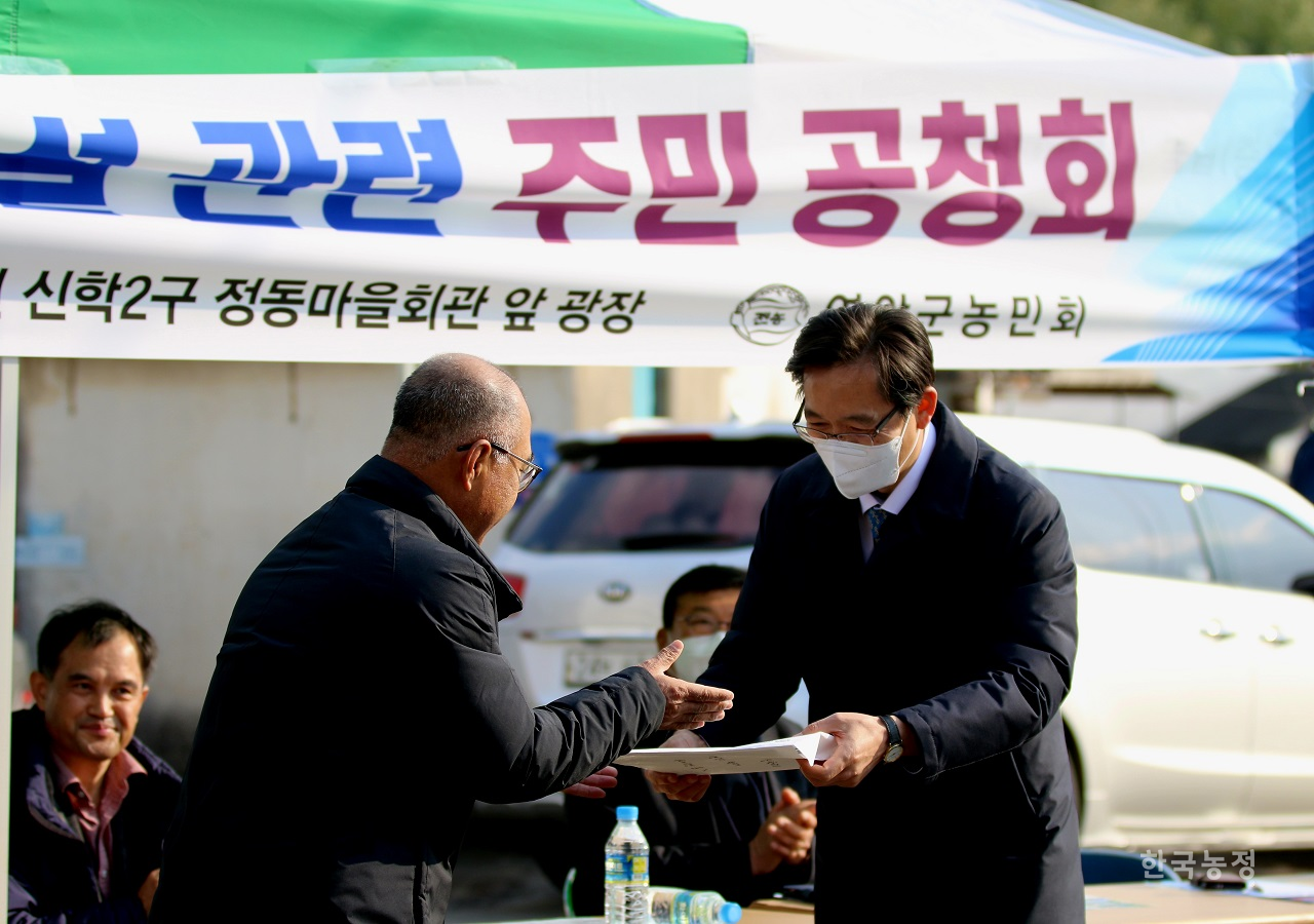 박웅 영암군농민회장(왼쪽)이 우승희 영암군수에게 영암제2변전소 건설 반대 주민 서명부를 전달하고 있다.