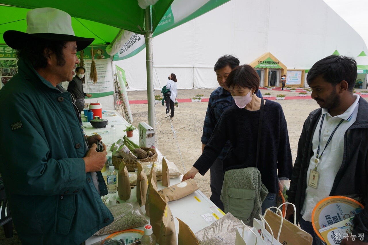 지난 6일 전북 김제시 종자산업진흥센터 일원에서 열린 2023 국제종자박람회 중 전북 농민들의 토종씨앗 부스를 방문한 관람객들이 고창 농민 김남수(왼쪽)씨로부터 토종쌀에 대한 설명을 듣고 있다.