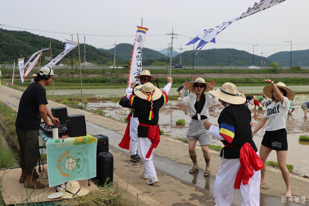 지난달 31일 농업먹거리청년모임과 임진여울영농조합법인이 개최한 도농교류 행사에 참가한 농민과 시민들이 경기도 연천군 군남면의 친환경 논 앞의 논길 위에서 DJ 조성우씨(왼쪽)의 디제잉에 맞춰 춤추고 있다.