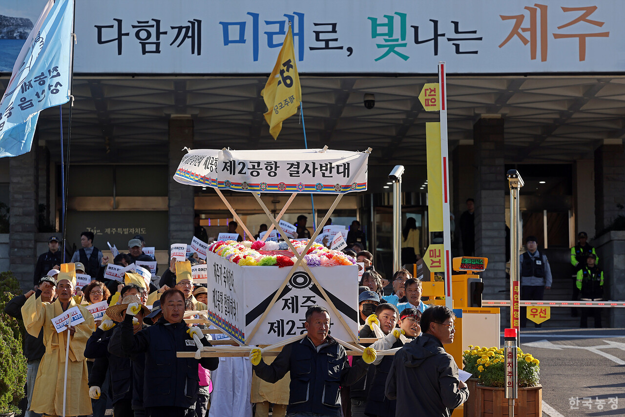 제주 제2공항 반대투쟁 10년을 맞아 지난 10일 제주도청 앞에서 열린 제주농민대회에서 농민들이 '제2공항 결사반대 제주가 죽어간다 제2공항 철회하라' 등이 적힌 상여를 메고 도청 앞을 행진하고 있다. 한승호 기자