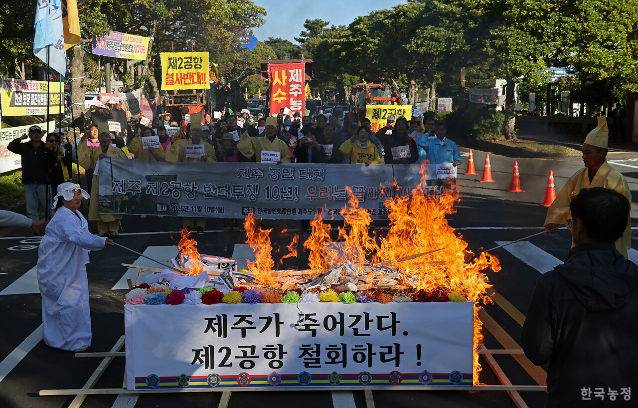 제주 제2공항 반대투쟁 10년을 맞아 지난 10일 제주도청 앞에서 열린 제주농민대회에서 농민들이 '제주가 죽어간다 제2공항 철회하라' 등이 적힌 상여를 불태우고 있다. 한승호 기자