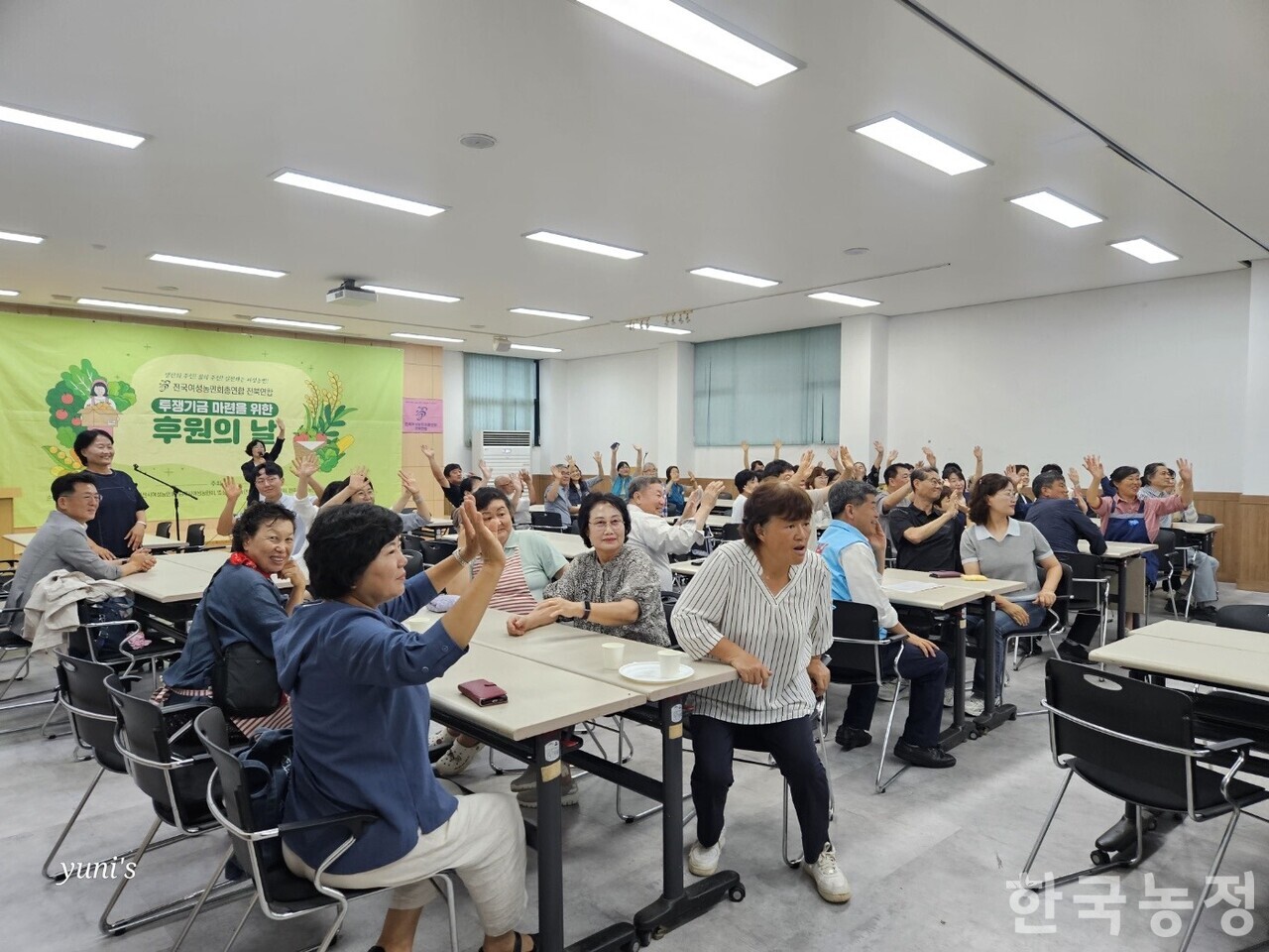 지난 9일 전주시 전북농업인회관에서 후원 행사를 마련한 전국여성농민회총연합 전북연합 회원들과 초대된 손님들이 한자리에 모여 손을 흔들고 있다.